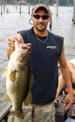 Bryan Mannino from Independence, La. with a 23.5 inches long bass weighing 8 lbs. Caught on a watermelon red Zoom lizard 5-8-09 2ft of water.