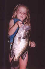 7 year old Tori Russell shows off her 16 1/2 inch Lake Fork Crappie. This Big Crappie was caught on 8 lb test line using a Jig.