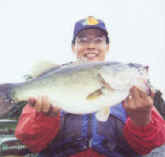 Kanako from Japan display this nice Lake Fork bass caught while fishing with pro guide John Tanner.